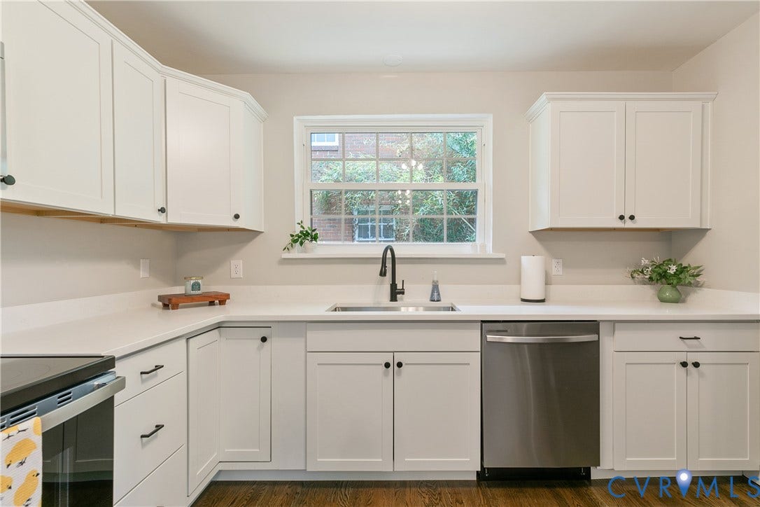 3512 Fendall Avenue, Edgewood, Richmond, VA 23222 White shaker cabinetry with black hardware, white countertops, stainless steel dishwasher, undermount sink with a black gooseneck faucet, and wood-finish flooring