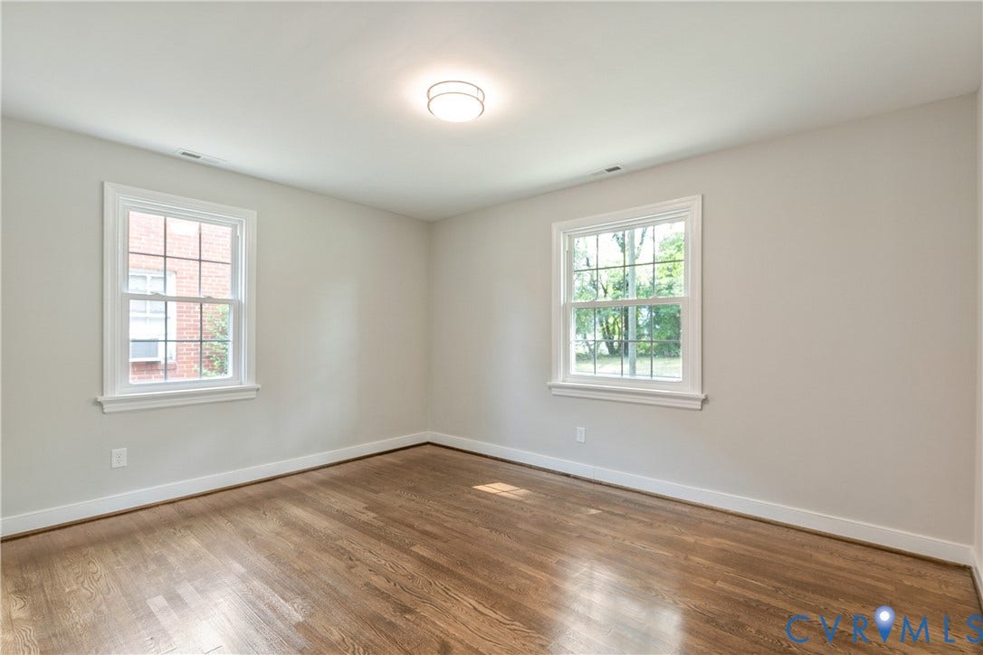 3512 Fendall Avenue, Edgewood, Richmond, VA 23222 Room featuring wood-finish flooring, light-toned wall paint, white baseboards, and white window trim