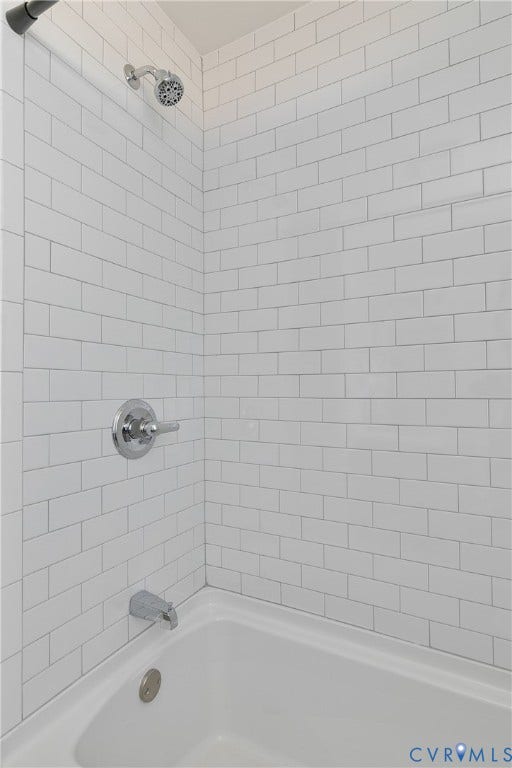3512 Fendall Avenue, Edgewood, Richmond, VA 23222 Bathtub with white subway tile surround, chrome fixtures, and a ceiling-mounted showerhead