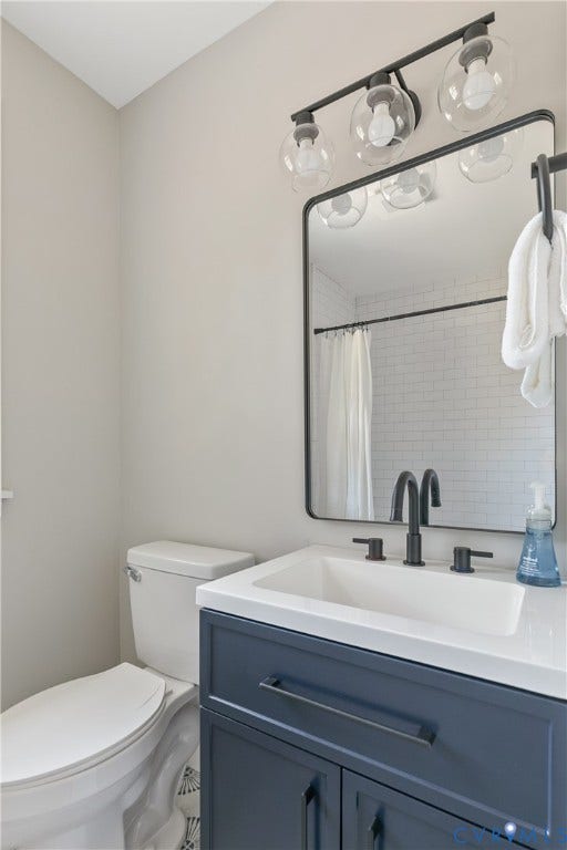 3512 Fendall Avenue, Edgewood, Richmond, VA 23222 Bathroom vanity featuring a white integrated sink, dark blue cabinetry, and matte black hardware