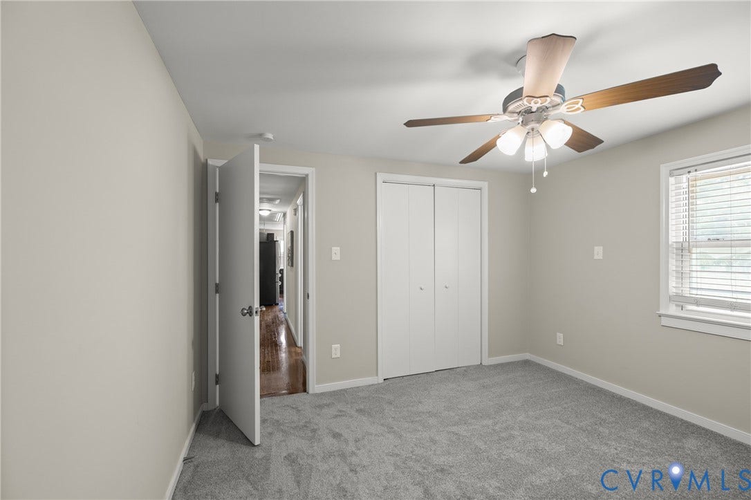 Bedroom featuring neutral-toned walls and gray carpeting