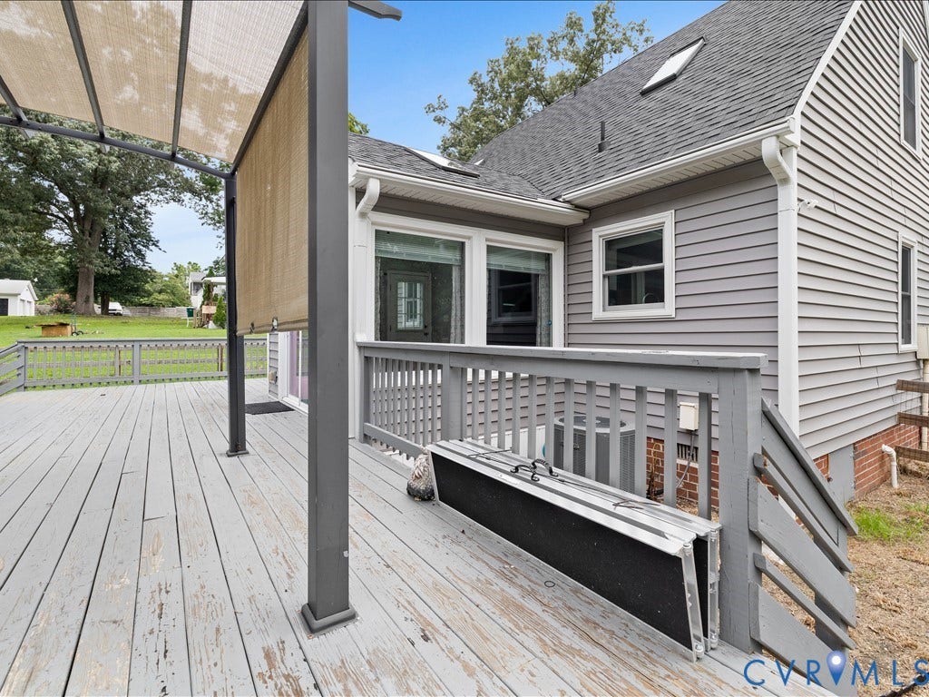 12230 Harrowgate Road, Chesterfield, VA 23831 Spacious outdoor deck featuring a pergola with retractable shade, durable wood deck flooring, and painted railings