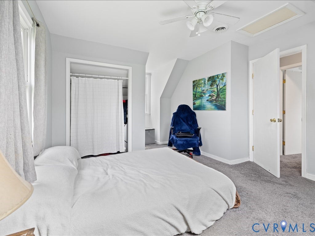 12230 Harrowgate Road, Chesterfield, VA 23831 Carpeted room with a ceiling fan, two windows with drapery, a closet with a privacy curtain, and a white interior door