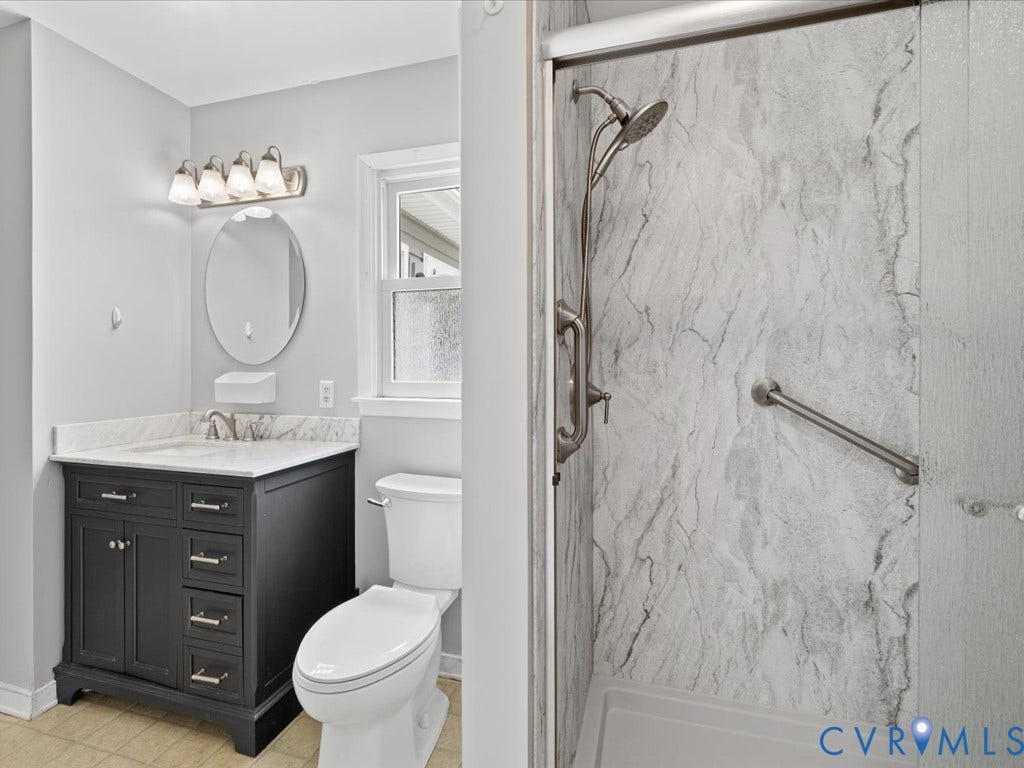 12230 Harrowgate Road, Chesterfield, VA 23831 Bathroom vanity featuring a dark wood finish cabinet with brushed nickel hardware, a white countertop, and an oval mirror