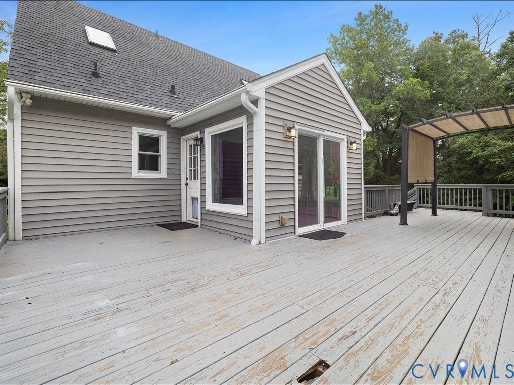 12230 Harrowgate Road, Chesterfield, VA 23831 Spacious outdoor deck with a pergola, offering direct access to the interior through a glass sliding door and an additional entry door
