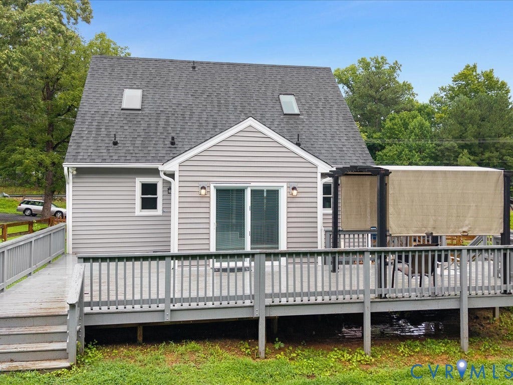 12230 Harrowgate Road, Chesterfield, VA 23831 Rear exterior featuring grey siding, a multi-level deck, and a dark shingle roof with two skylights