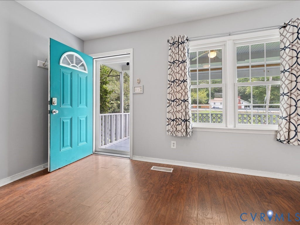 12230 Harrowgate Road, Chesterfield, VA 23831 Bright entryway featuring a vibrant turquoise door with an arched window, wood-finish flooring, light grey walls, and two multi-pane windows