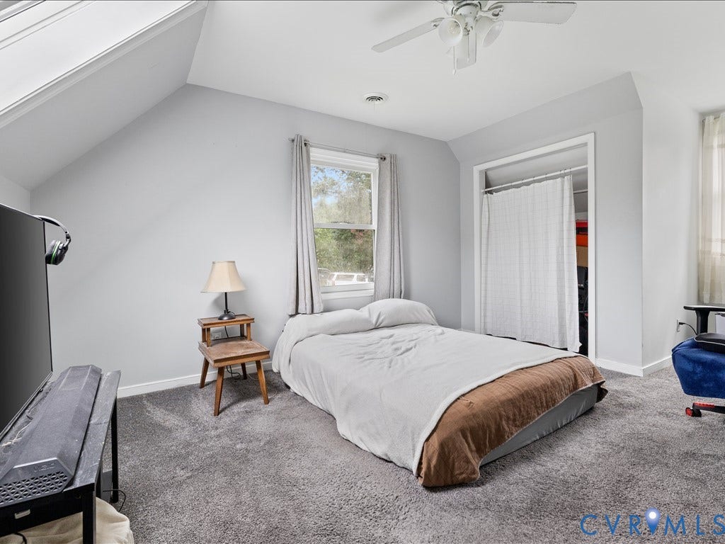 12230 Harrowgate Road, Chesterfield, VA 23831 Carpeted room featuring a window with natural light, a ceiling fan, and an open closet space