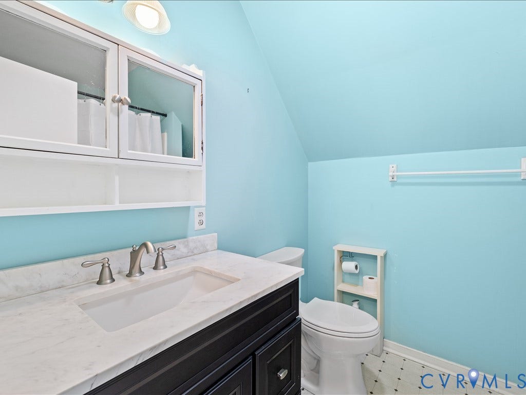 12230 Harrowgate Road, Chesterfield, VA 23831 Bathroom vanity featuring a white countertop with integrated sink, brushed nickel faucet, and dark wood-finish cabinetry