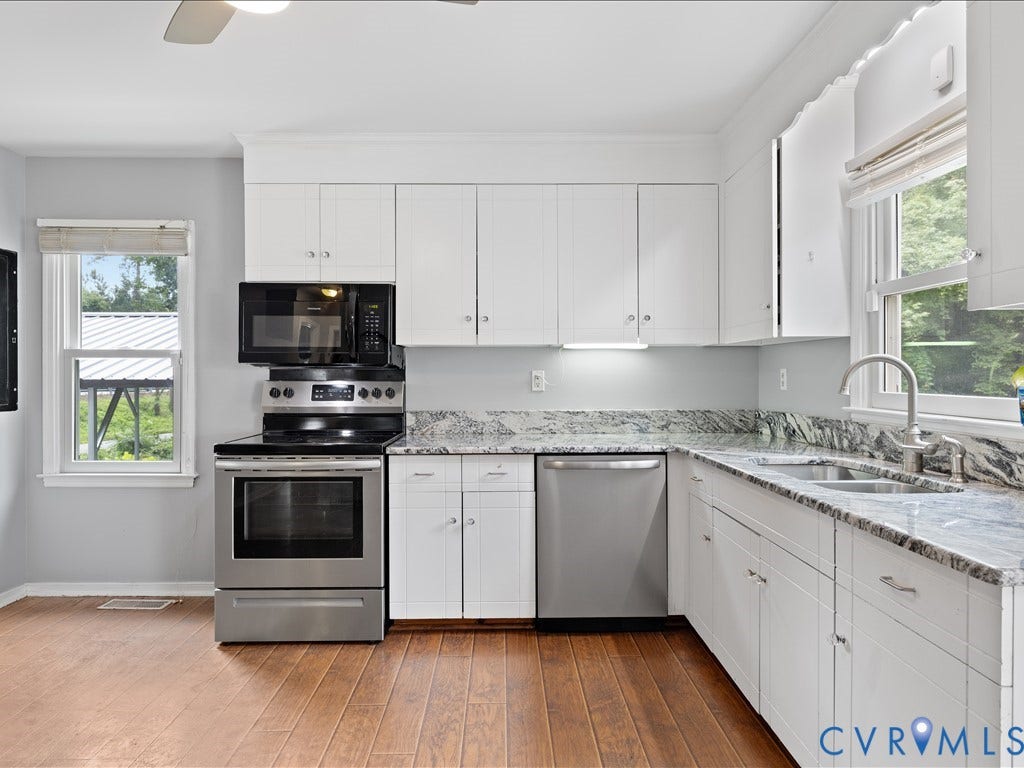 12230 Harrowgate Road, Chesterfield, VA 23831 Kitchen featuring wood-finish flooring, white cabinetry, and light gray walls
