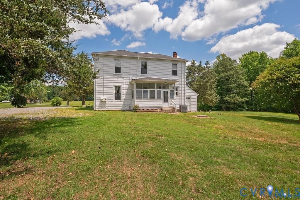 11300 Aspen Grove Drive, Glen Allen, VA 23059 Two-story residence with white siding, featuring a screened-in porch with white railings, a gravel driveway, and a detached shed