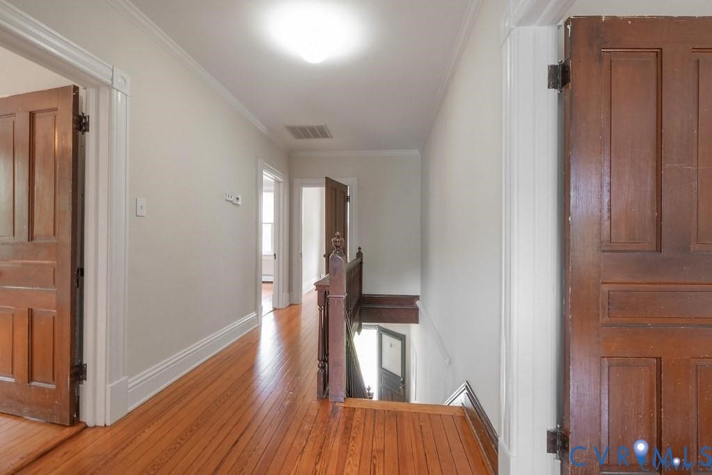 11300 Aspen Grove Drive, Glen Allen, VA 23059 Hallway featuring wood-finish flooring, white baseboards, and classic panel doors