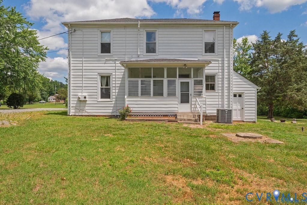 11300 Aspen Grove Drive, Glen Allen, VA 23059 Rear exterior featuring white horizontal siding, a screened-in porch with steps, an attached outbuilding, and mature trees in the background