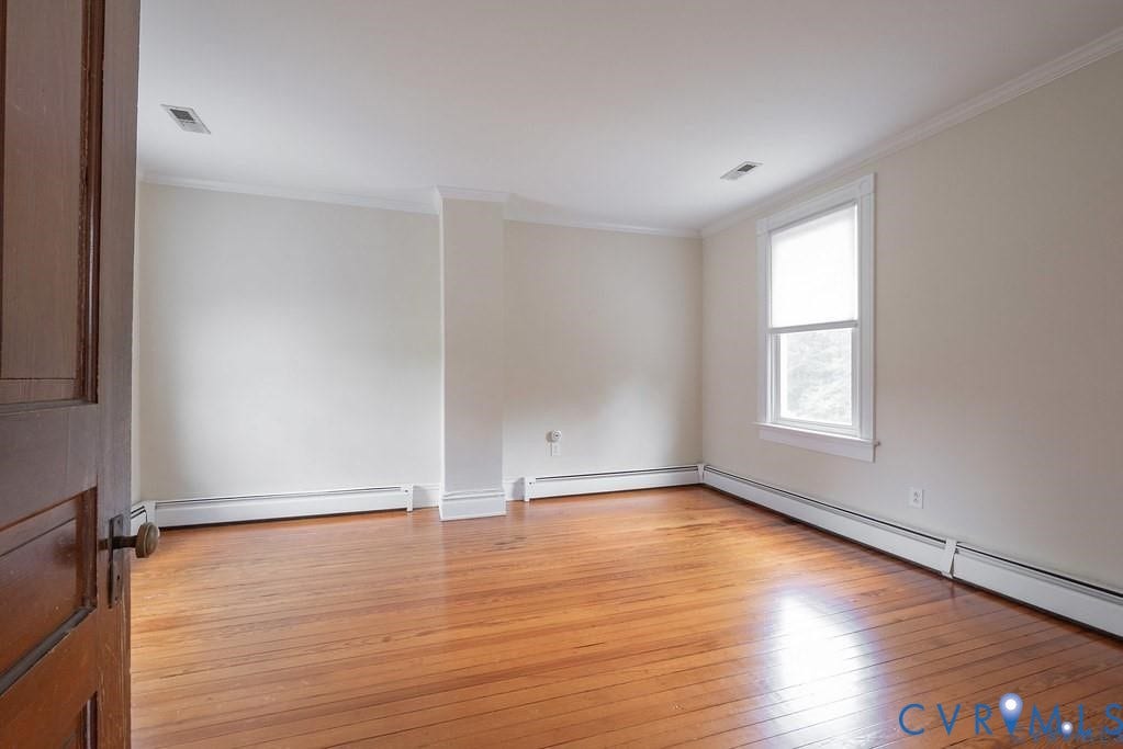 11300 Aspen Grove Drive, Glen Allen, VA 23059 Hardwood flooring throughout featuring white baseboard trim and crown molding