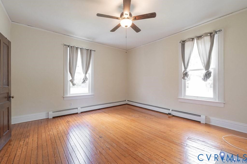 11300 Aspen Grove Drive, Glen Allen, VA 23059 Hardwood flooring complemented by white trim, two windows, and a ceiling fan with integrated lighting
