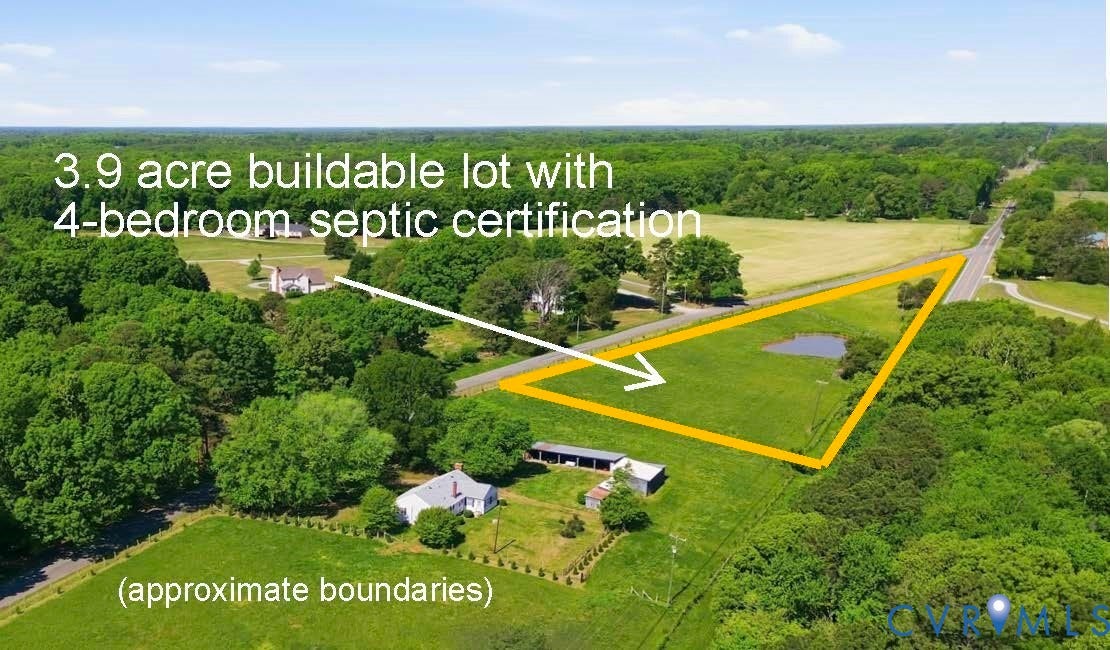 3.9-acre buildable lot featuring a natural pond, extensive green space, and surrounding mature trees