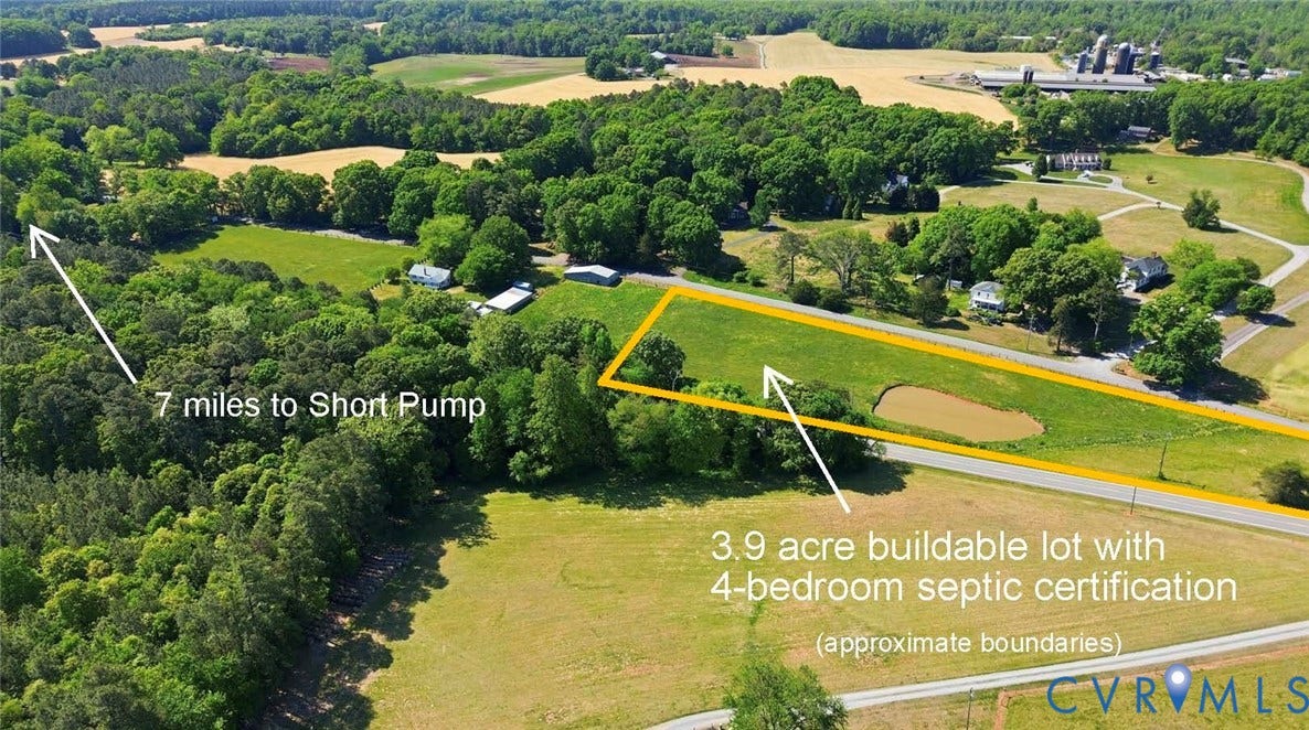 Expansive 3.9-acre buildable lot featuring a prominent pond
