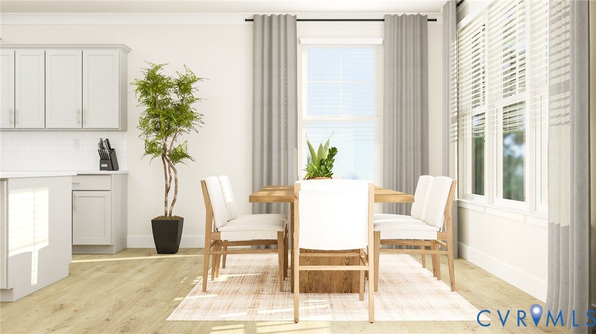 Open-concept dining area featuring a wood-finish dining table, light wood-finish flooring, white baseboards, and multiple windows with white blinds