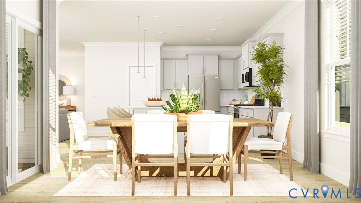 Open-concept living space featuring wood-finish flooring, recessed lighting, white cabinetry, and stainless steel appliances