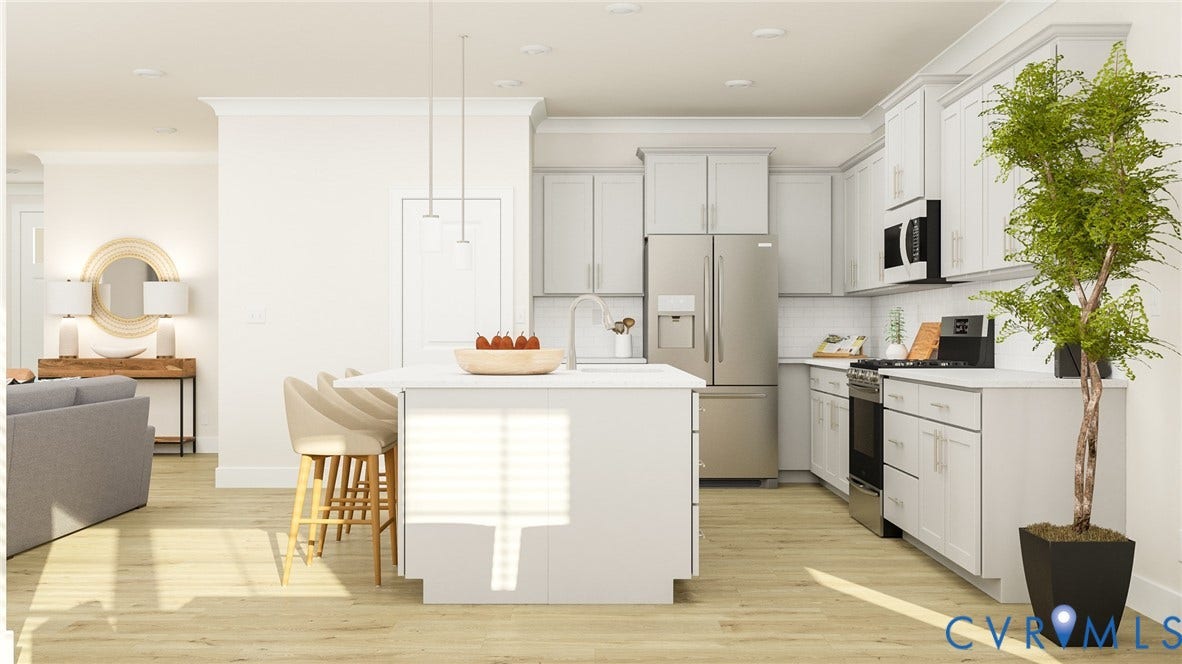 Modern kitchen featuring an island with seating, pendant lighting, stainless steel appliances, white cabinetry, and wood-finish flooring