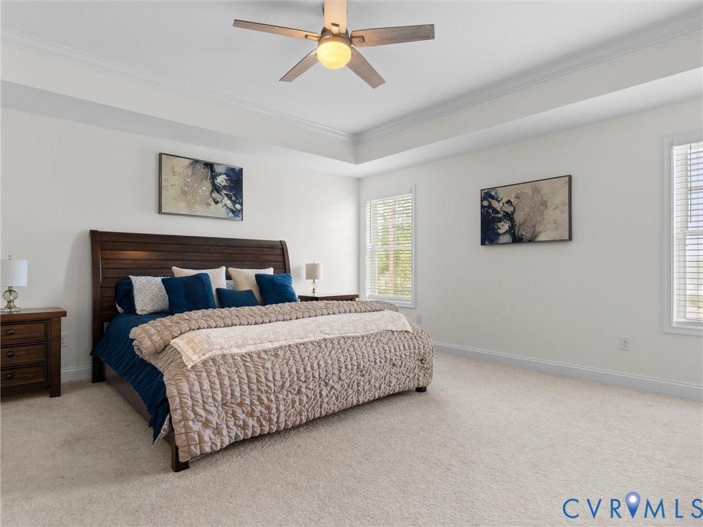 6642 Stonewolf Court, Moseley, VA 23120 Carpeted bedroom featuring a tray ceiling, ceiling fan and ensuite primary bathroom
