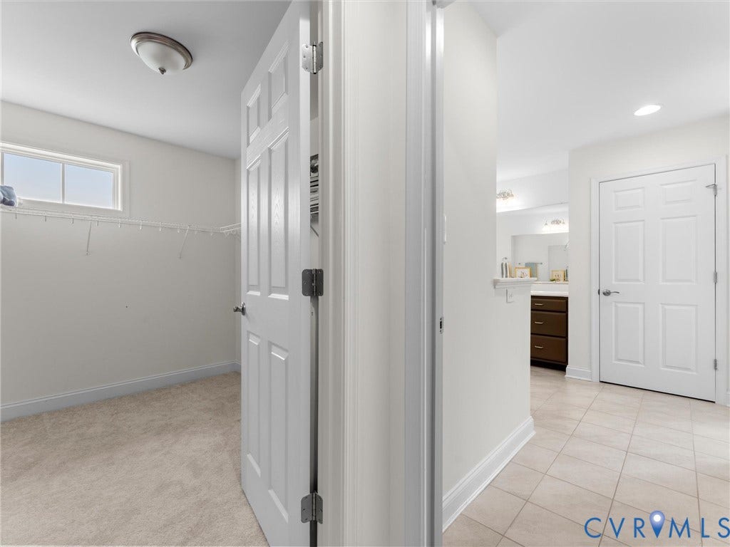 6642 Stonewolf Court, Moseley, VA 23120 There are two large His/Hers walk-in closets and enters into the Ensuite Spa Primary Bathroom