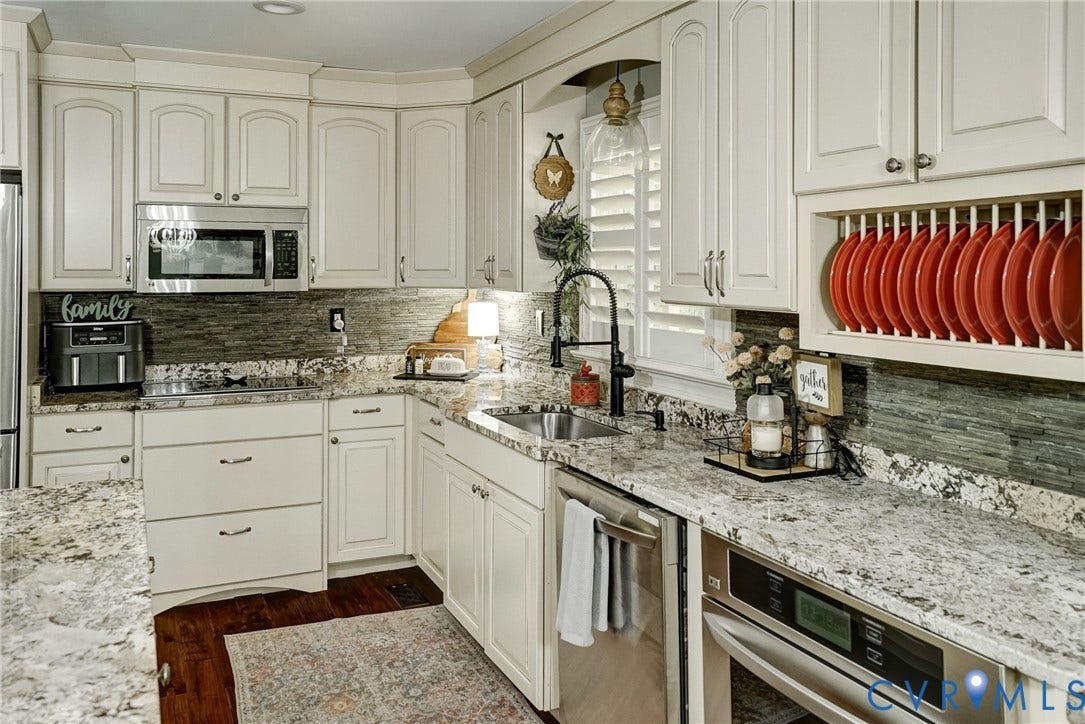 1174 Dorset Road, Powhatan, VA 23139 Kitchen featuring light cabinetry, granite countertops, a stone tile backsplash, stainless steel appliances, and wood-finish flooring