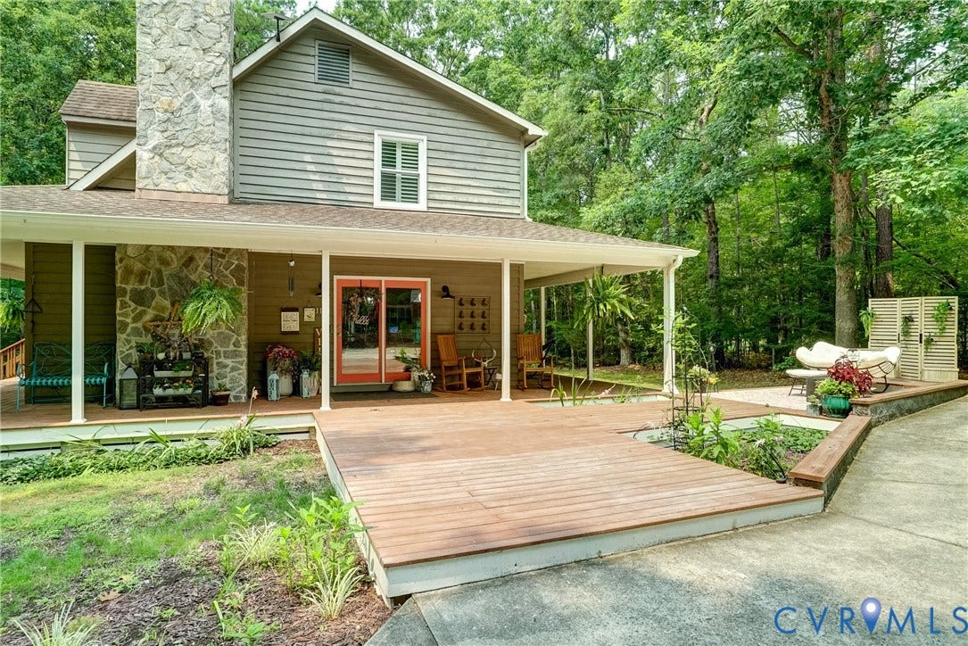 1174 Dorset Road, Powhatan, VA 23139 Spacious outdoor entertaining area featuring a wood-finish deck, covered porch, and a dedicated patio space