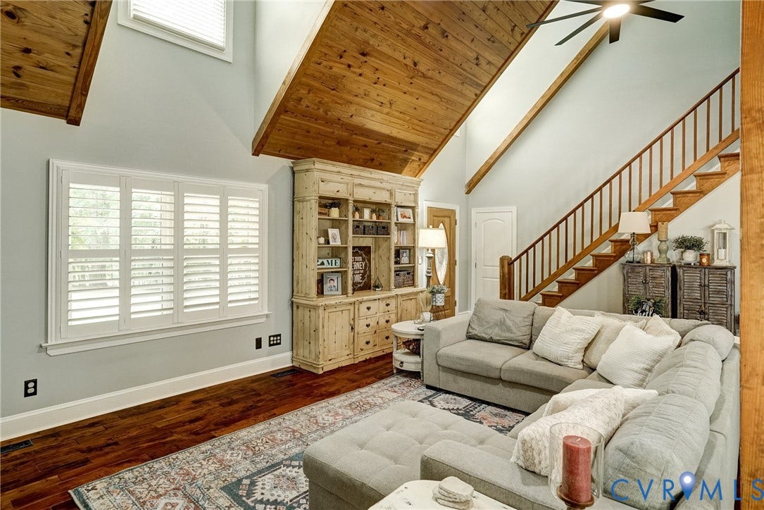 1174 Dorset Road, Powhatan, VA 23139 Living area featuring soaring vaulted wood-paneled ceilings, rich wood-finish flooring, and a natural wood staircase with balusters