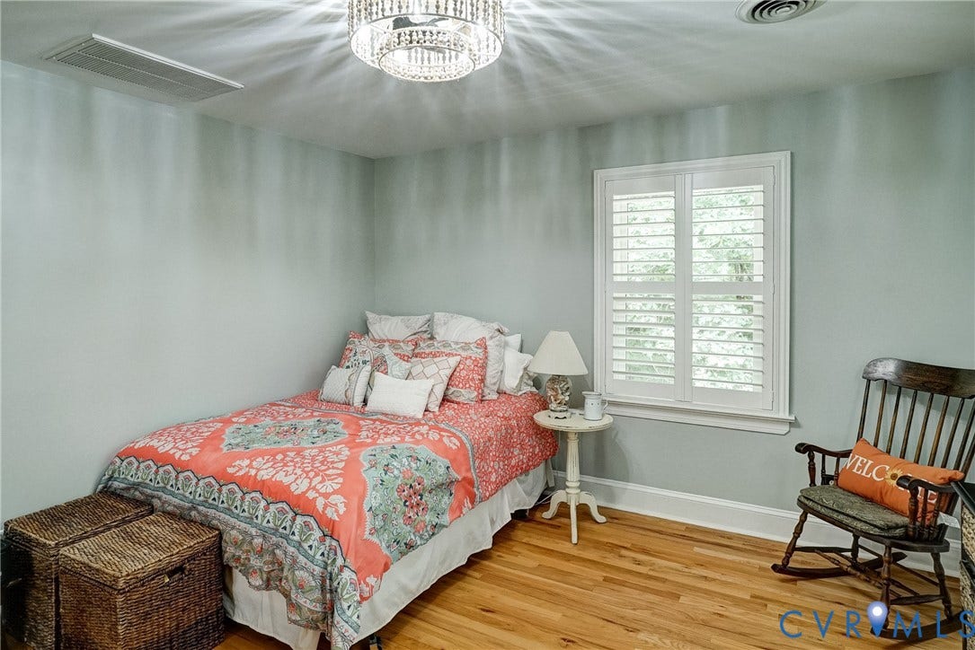 1174 Dorset Road, Powhatan, VA 23139 Hardwood flooring, white window shutters, crystal chandelier light fixture, recessed air vent, and wall-mounted air vent