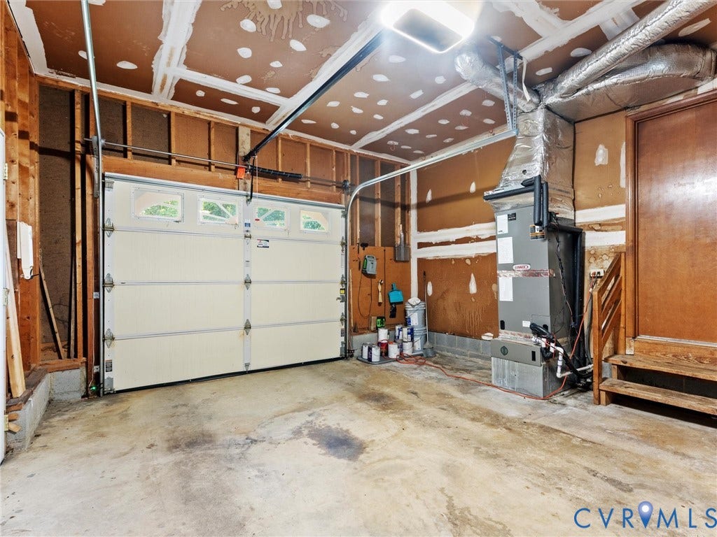Single-vehicle garage with an automatic overhead door featuring transom-style window inserts