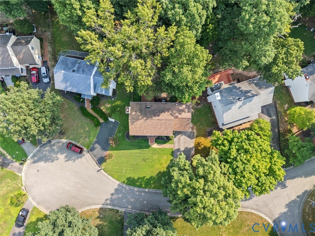Property situated on a cul-de-sac with mature trees and a manicured lawn