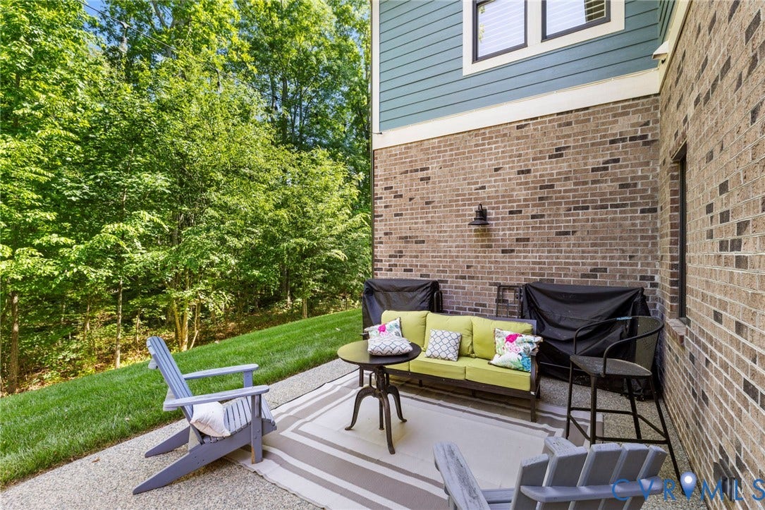 1925 Muswell Court, Hallsley, Midlothian, VA 23112 Expansive outdoor patio area featuring a textured concrete surface and direct access to a grassy incline