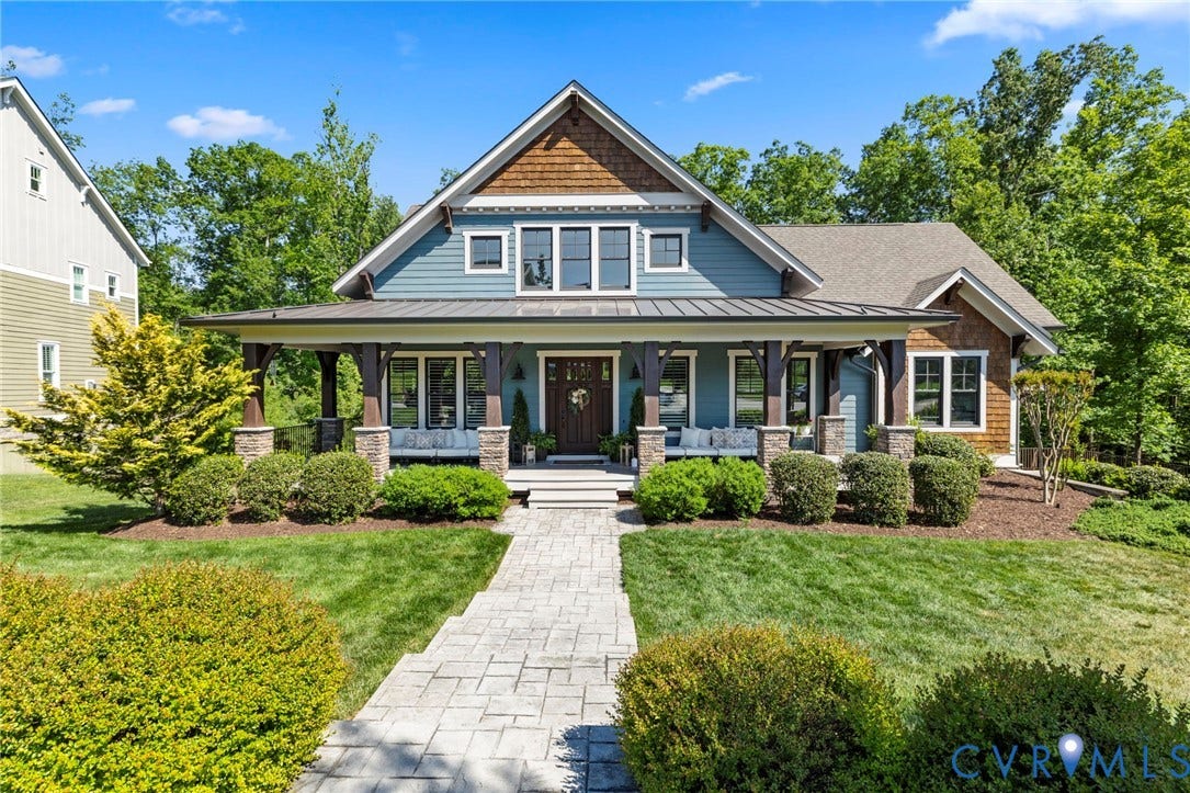 1925 Muswell Court, Hallsley, Midlothian, VA 23112 Craftsman-style home featuring a covered front porch with stone-clad columns, a dark wood entry door, and a light blue siding facade