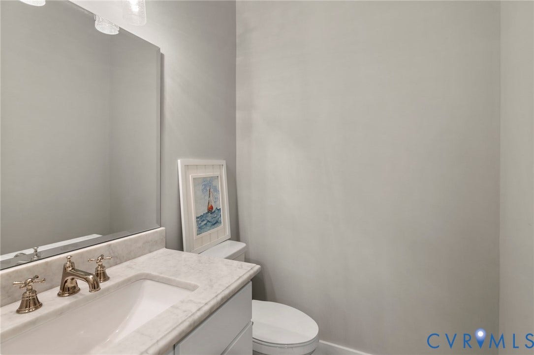 1925 Muswell Court, Hallsley, Midlothian, VA 23112 Vanity with an integrated rectangular sink, light-toned countertop, and antique brass-finish faucet