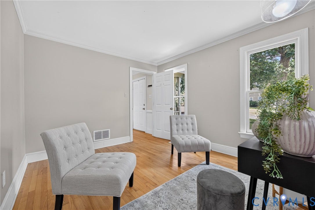 8436 Sir Lionel Place, Kingsland Wood, Ampthill, VA 23237 Hardwood flooring, light gray wall paint, crown molding, white trim, and a window providing natural illumination