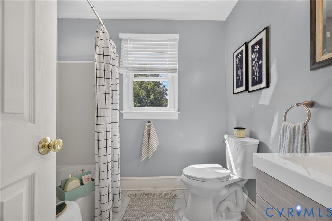 8436 Sir Lionel Place, Kingsland Wood, Ampthill, VA 23237 Bright, updated bathroom featuring soft gray walls, a white vessel sink with chrome fixtures, and a white toilet