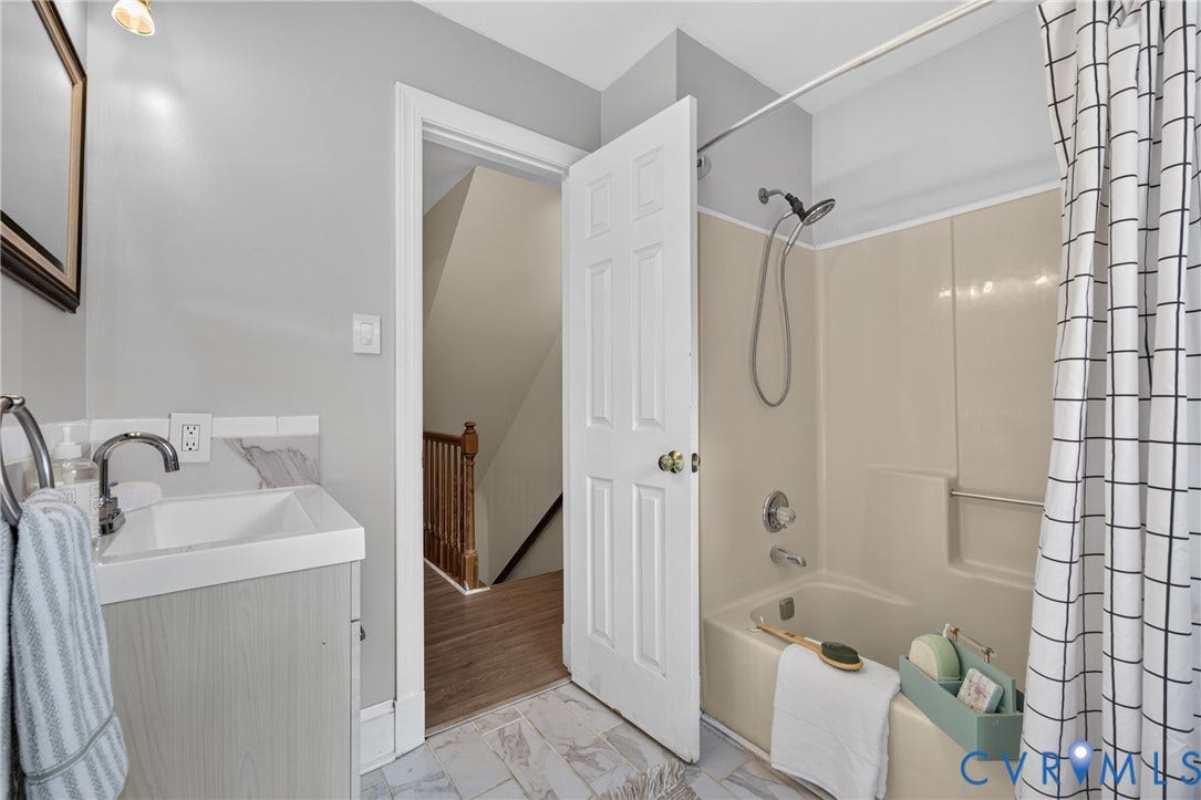 8436 Sir Lionel Place, Kingsland Wood, Ampthill, VA 23237 White integral sink with polished chrome faucet, light wood-finish vanity, and gray wall tile backsplash