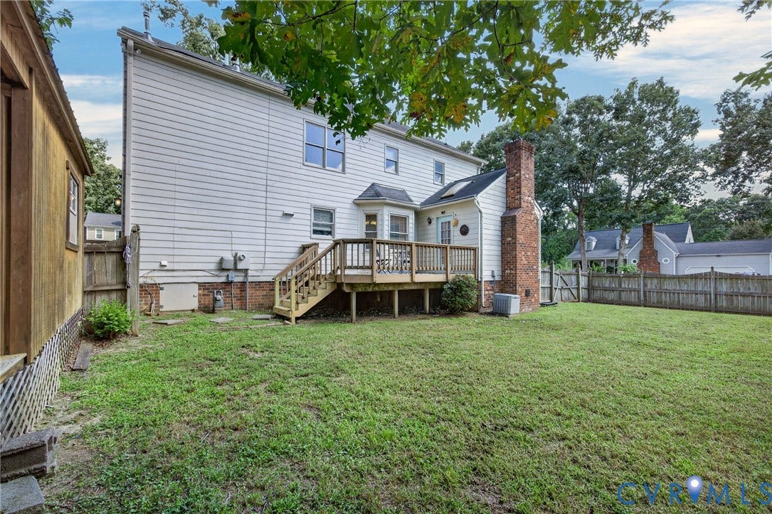 8436 Sir Lionel Place, Kingsland Wood, Ampthill, VA 23237 Spacious backyard with mature landscaping and level lawn, accessed via wooden deck with railings