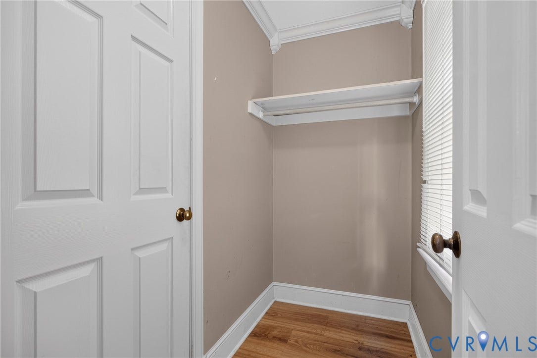 8436 Sir Lionel Place, Kingsland Wood, Ampthill, VA 23237 Built-in shelving with hanging rod, wood-finish flooring, and white trim