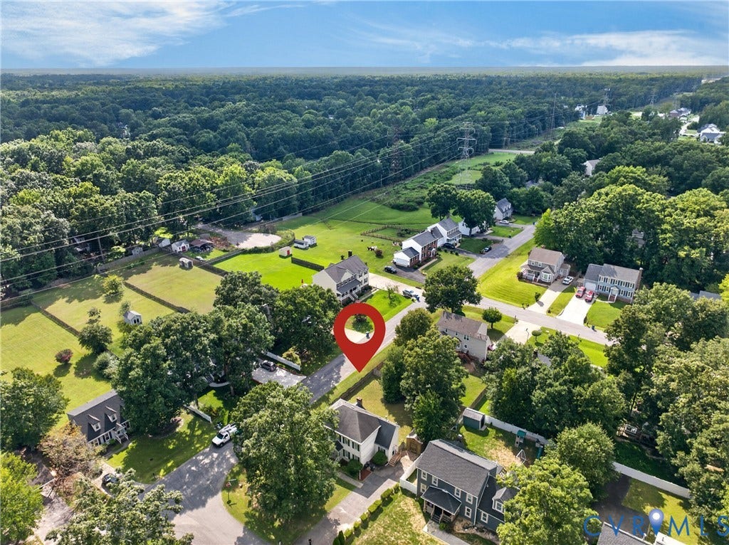 8436 Sir Lionel Place, Kingsland Wood, Ampthill, VA 23237 Aerial view showcasing a substantial residential property set on expansive grounds with mature landscaping, manicured lawn, and tree-lined perimeter