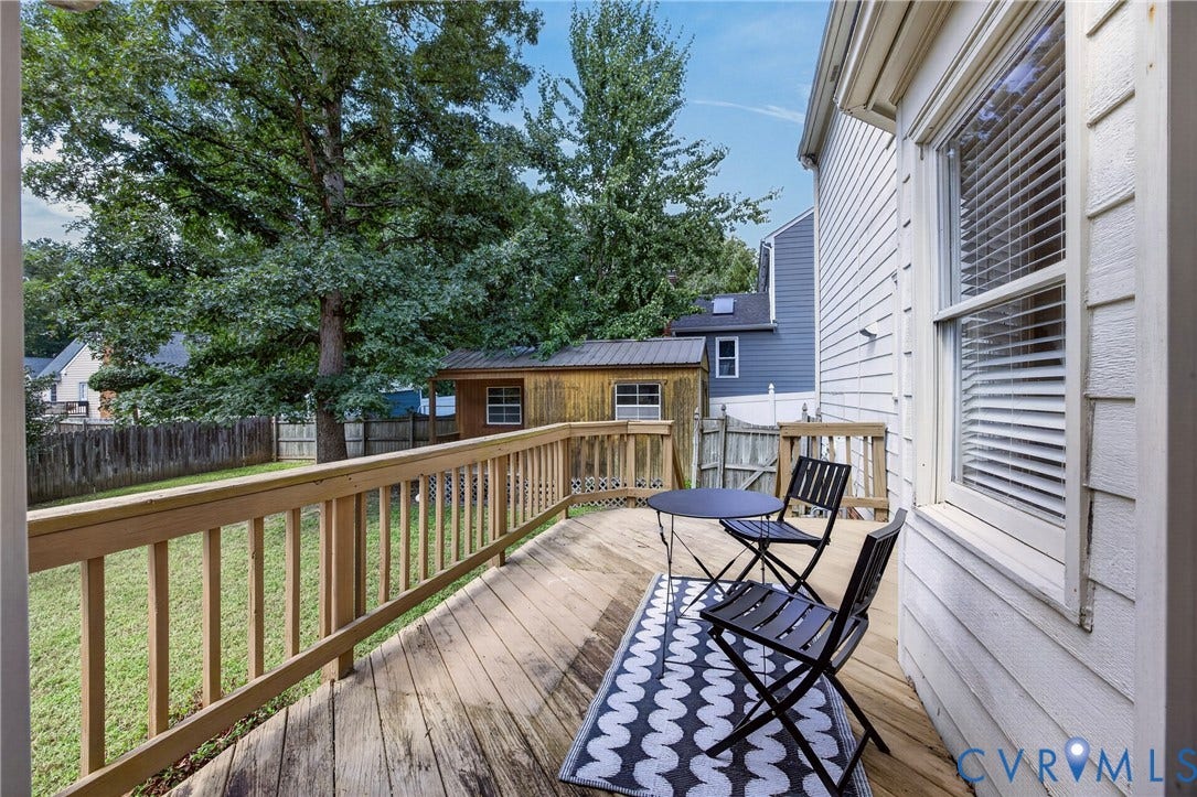 8436 Sir Lionel Place, Kingsland Wood, Ampthill, VA 23237 Expansive wood deck with a matching wood railing, overlooking a green lawn