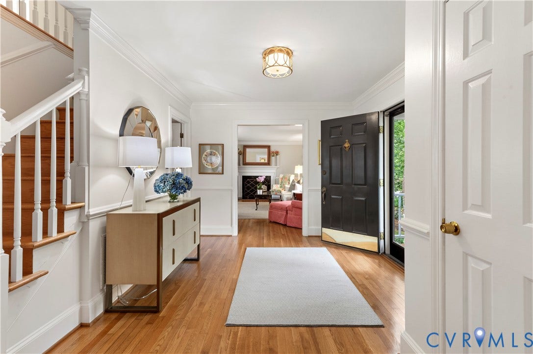 1905 Tunbridge Drive, Henrico, VA 23238 Foyer featuring hardwood flooring, a staircase with wood treads and white risers, crown molding, and a paneled entry door with brass hardware