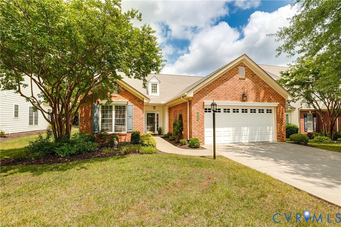 3817 Middletown Way, Crossridge, Henrico, VA 23060 Brick exterior with a white garage door, concrete driveway, and established landscaping