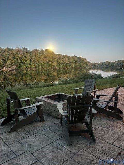 3655 Stone Harbor Drive, Midlothian, VA 23113 Stamped concrete patio featuring a built-in stone fire pit and lakefront access