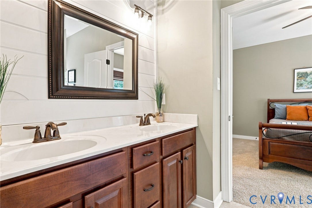 3655 Stone Harbor Drive, Midlothian, VA 23113 Dual vanity with integrated sinks and bronze-finish faucets set against a shiplap wall