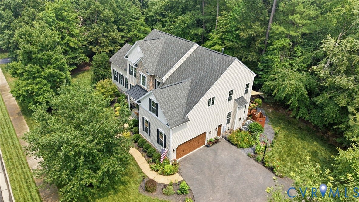 3655 Stone Harbor Drive, Midlothian, VA 23113 Two-story residence featuring a gray shingle roof, light-colored siding, and a stone facade accent