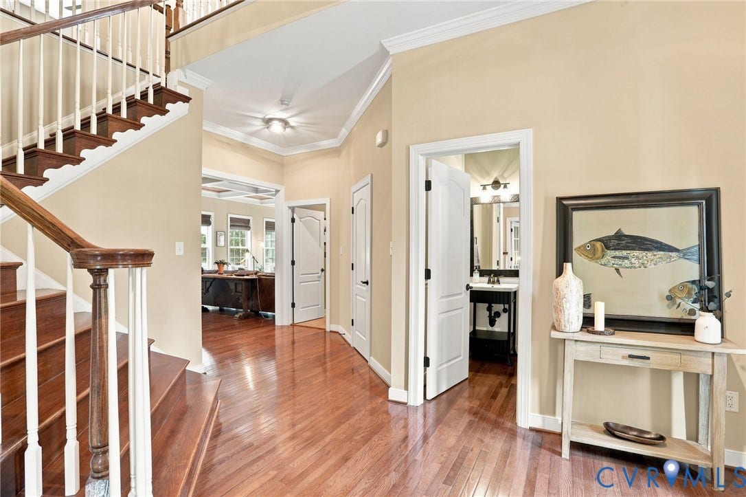 3655 Stone Harbor Drive, Midlothian, VA 23113 Foyer featuring wood-finish flooring, crown molding, and a staircase with wood treads and white risers
