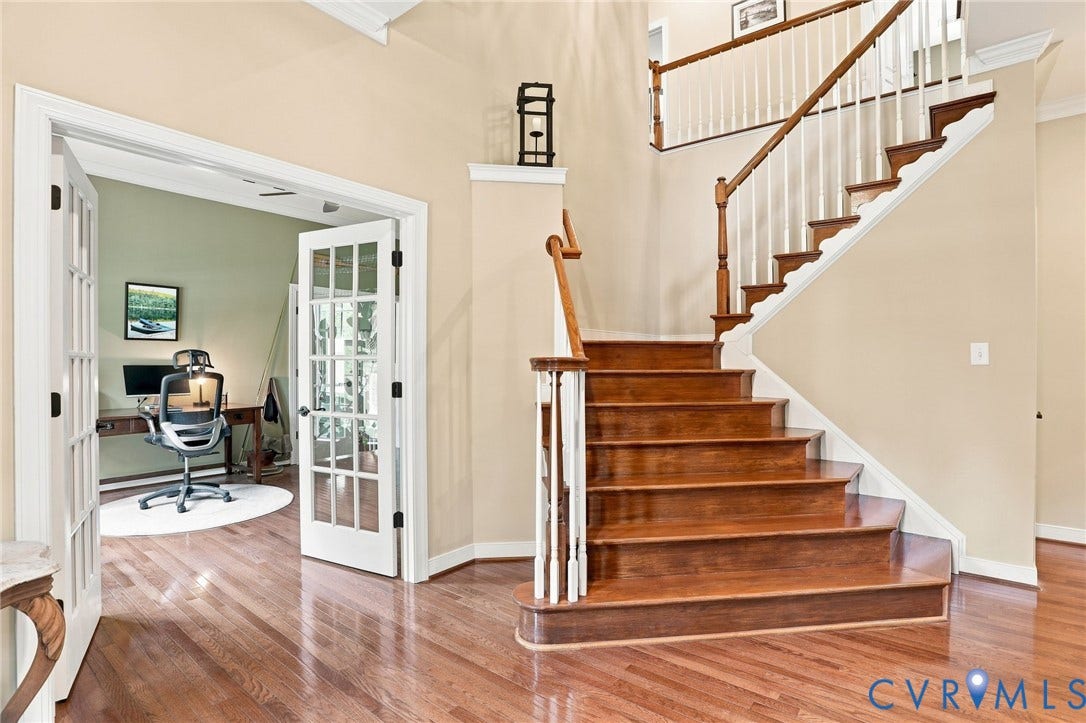 3655 Stone Harbor Drive, Midlothian, VA 23113 Hardwood flooring throughout the entry, a wood staircase with white balusters, and a room with French doors and light green walls