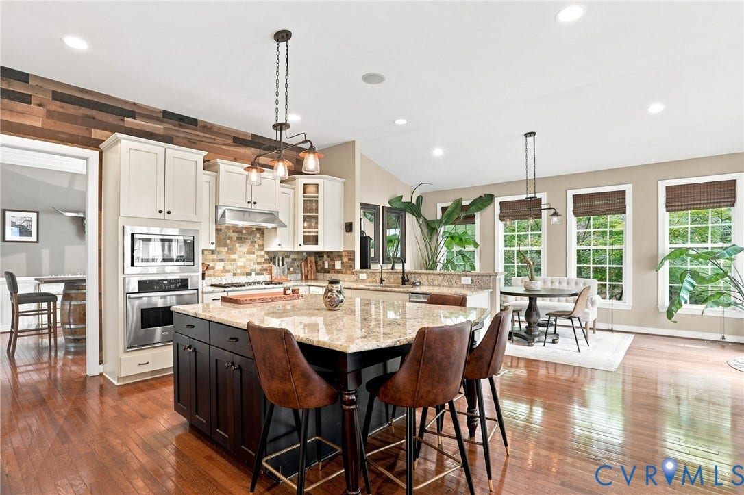 3655 Stone Harbor Drive, Midlothian, VA 23113 Spacious kitchen featuring an expansive island with a stone countertop, built-in stainless steel appliances, upper white cabinetry, and lower dark cabinetry
